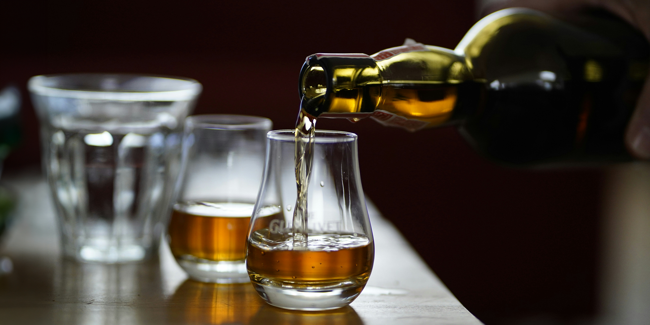 Whisky being served from a bottle.